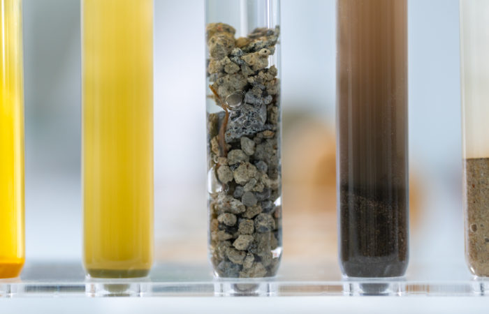 Rock sample in geology science laboratory research, mineral soil test in chemistry lab industry analysis work, geological stone material from nature with scientific equipment for industrial business Geology science laboratory research sample test analysis of nature dirtied ground environment